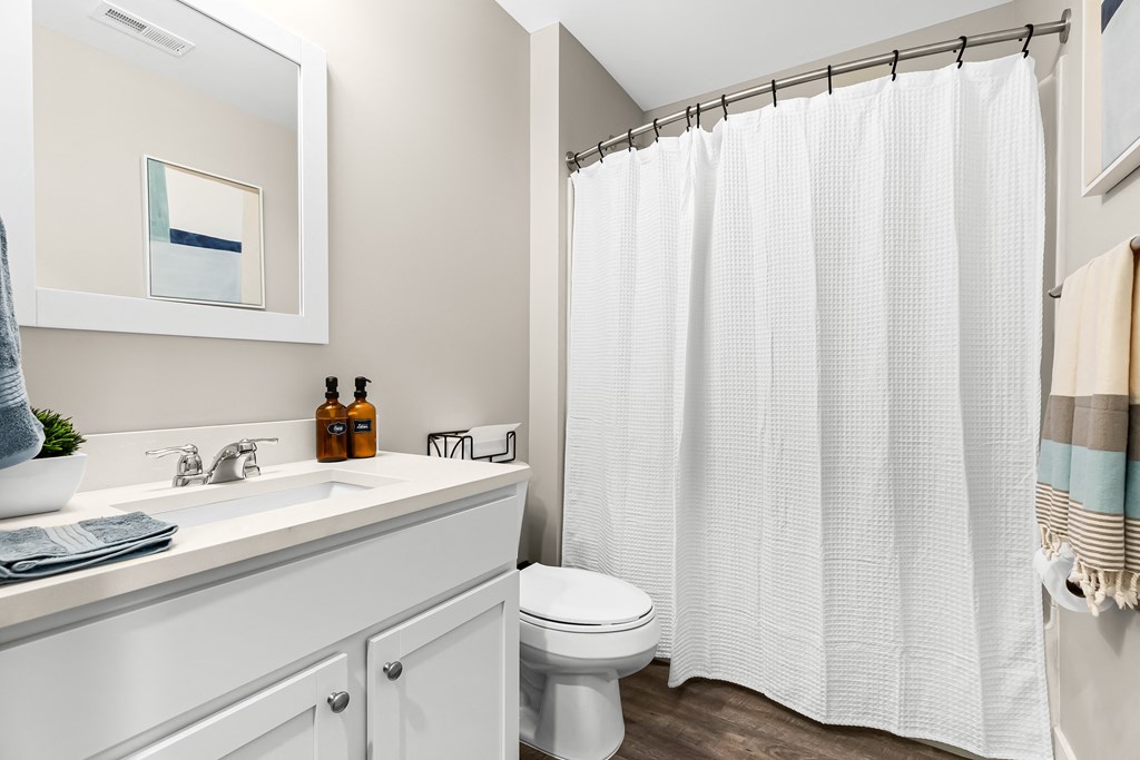 a bathroom with a shower and a sink and a toilet