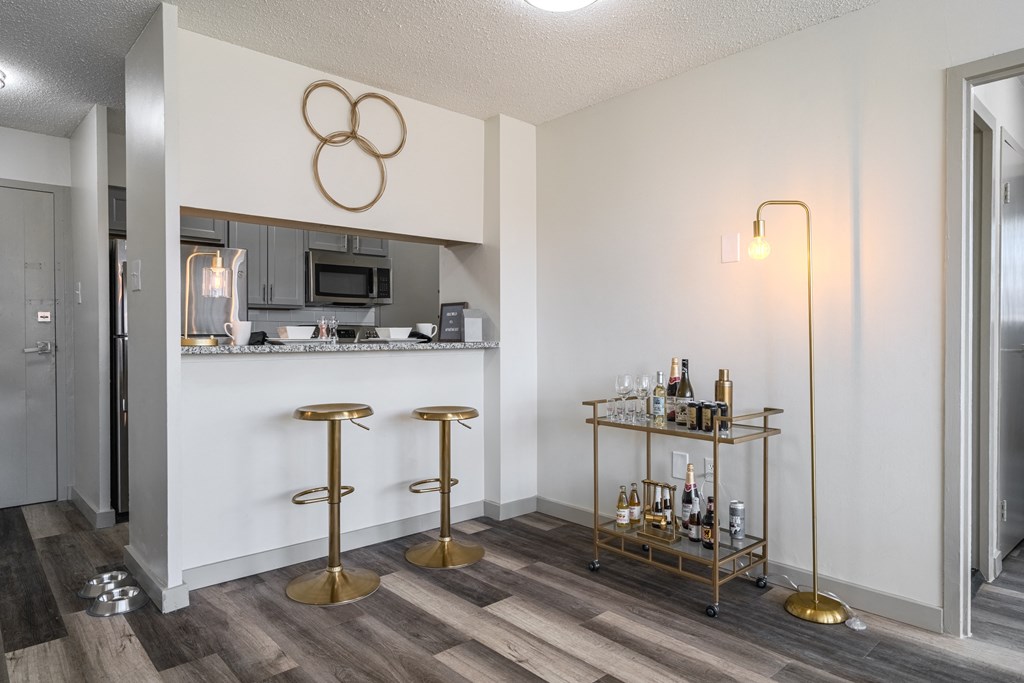 a living room with a bar and a kitchen