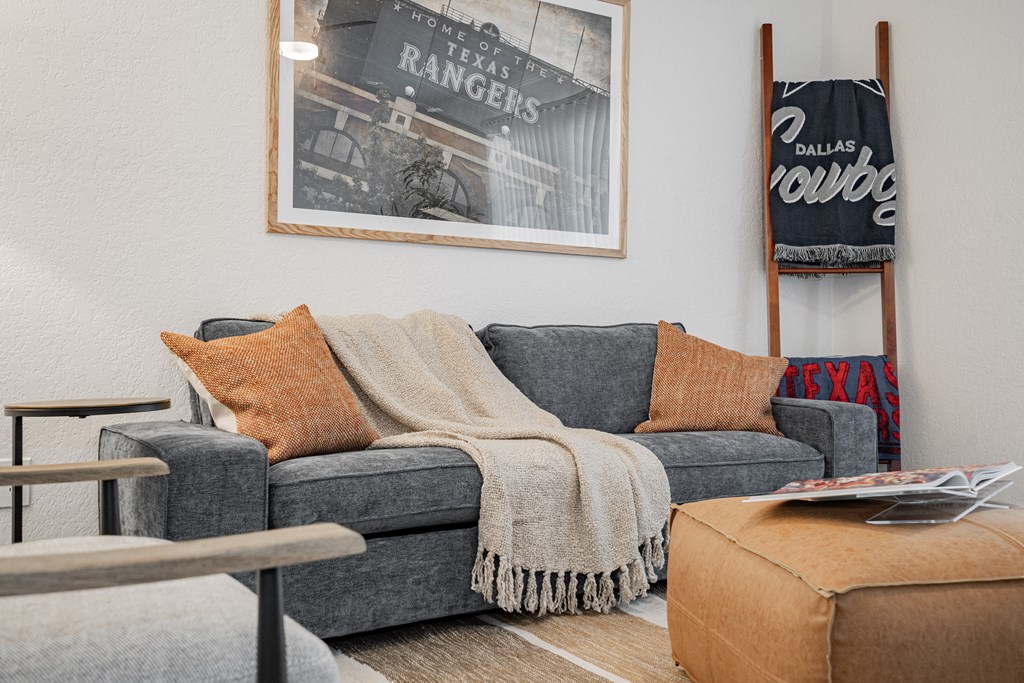 a living room with a couch with a blanket on it