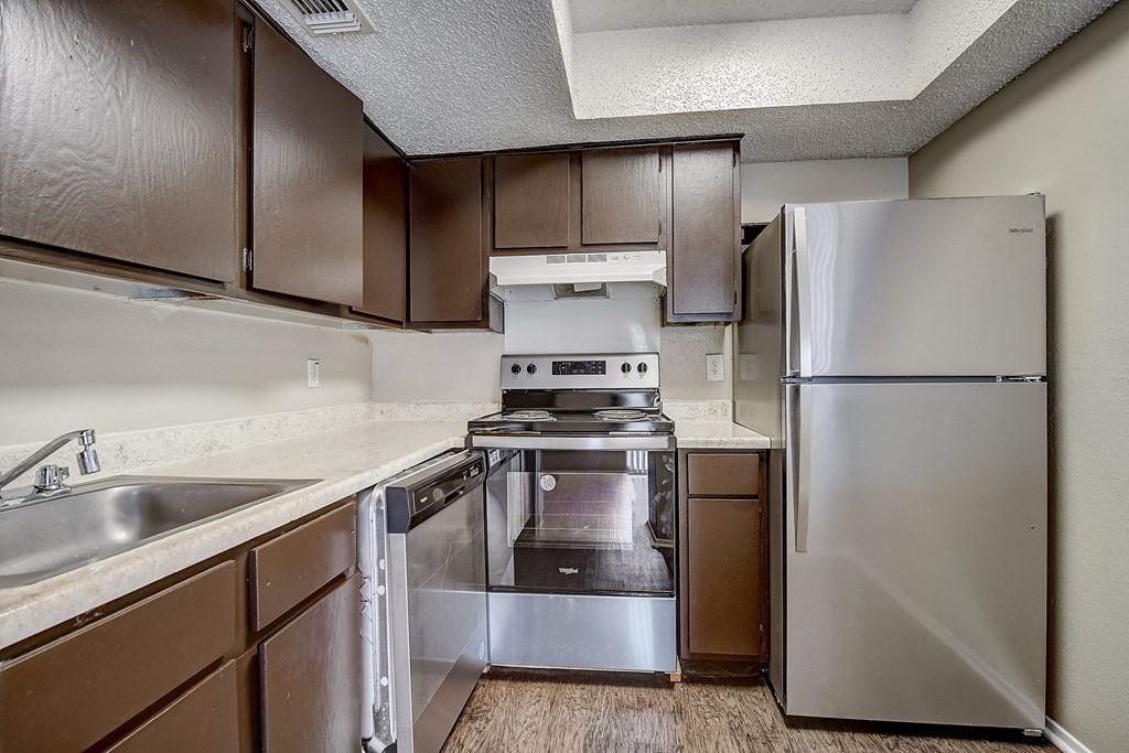 a kitchen with stainless steel appliances and wooden cabinets