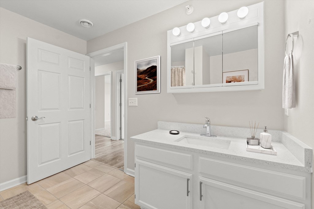 a bathroom with a sink and a mirror