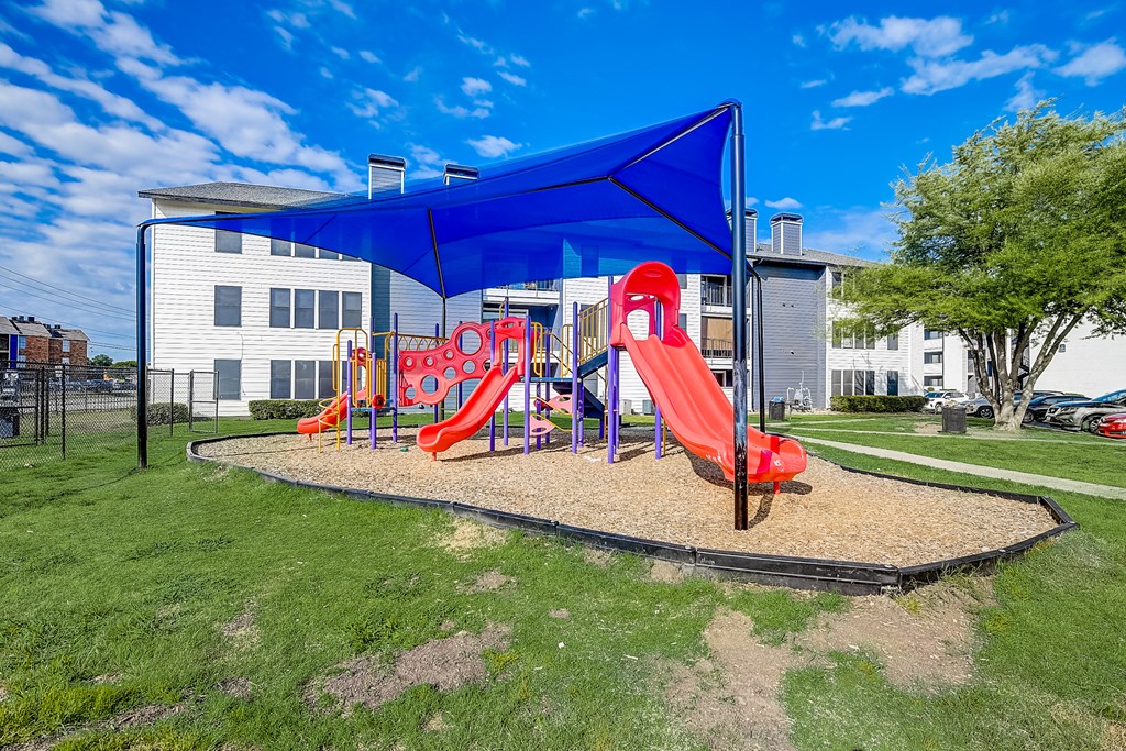 a playground with a blue canopy