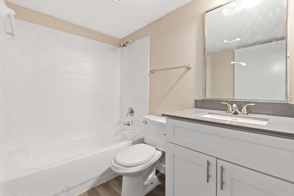 a bathroom with a sink toilet and a tub