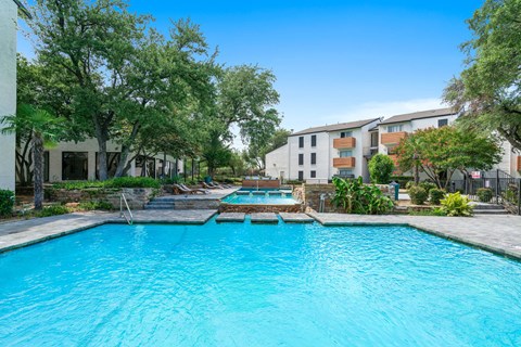 Tides at Esperanza community pool and hot tub with apartment buildings in the background