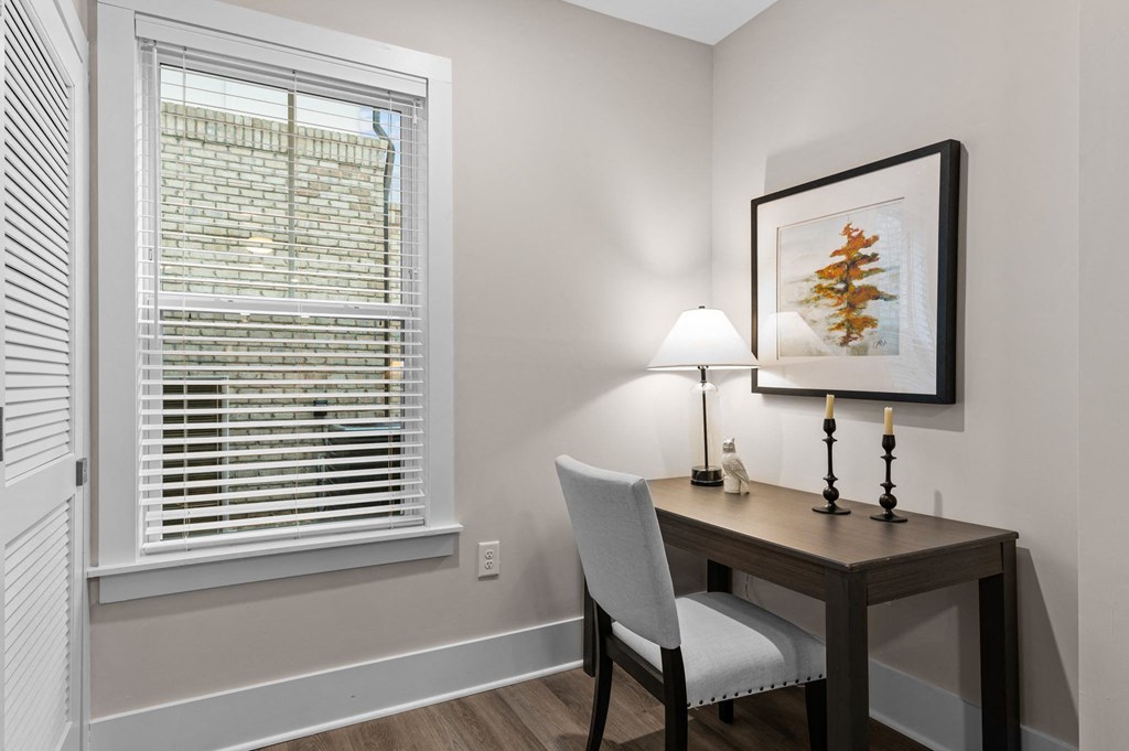 an office with a large window and a desk with a chair