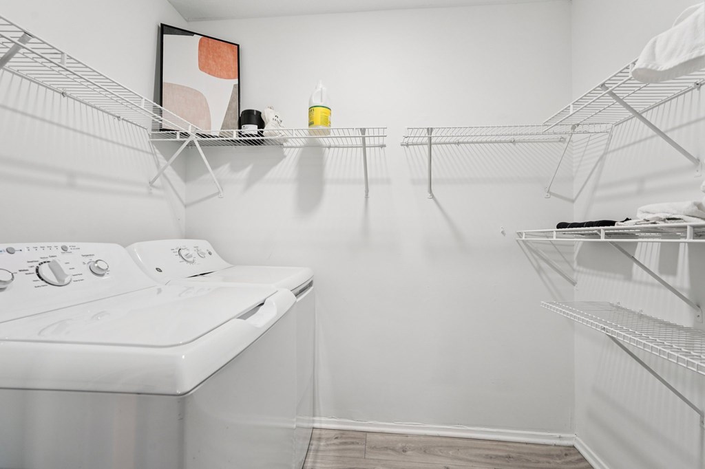 A white laundry room with a washer and dryer.
