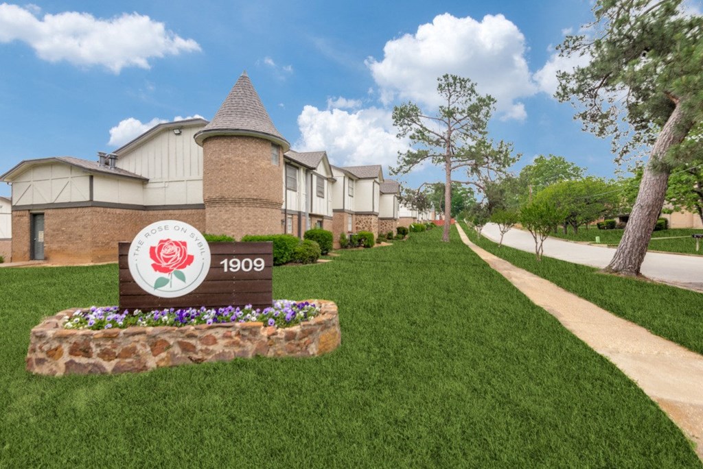 our apartments are located next to a sidewalk and green grass