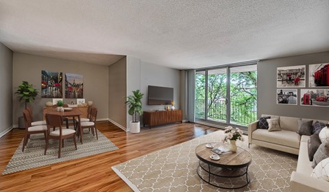 A living room with a dining table and chairs.