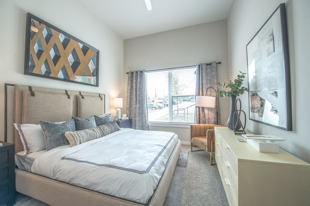 a bedroom with a large bed and a window