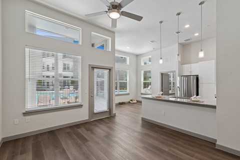A spacious room with a ceiling fan and a long counter.