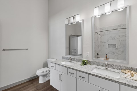 A bathroom with a white toilet, a sink, and a mirror.