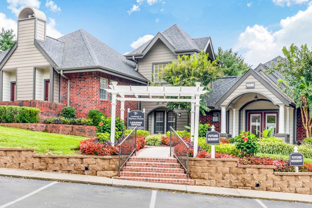 a large house with a stone wall in front of it