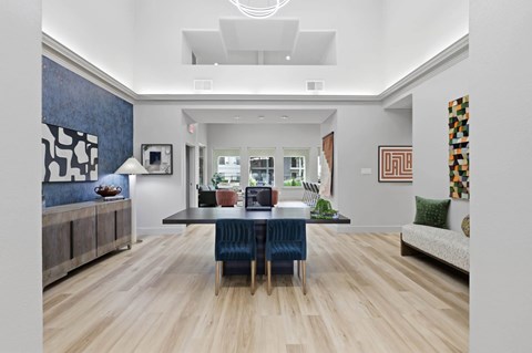 A dining room with a table set for four.
