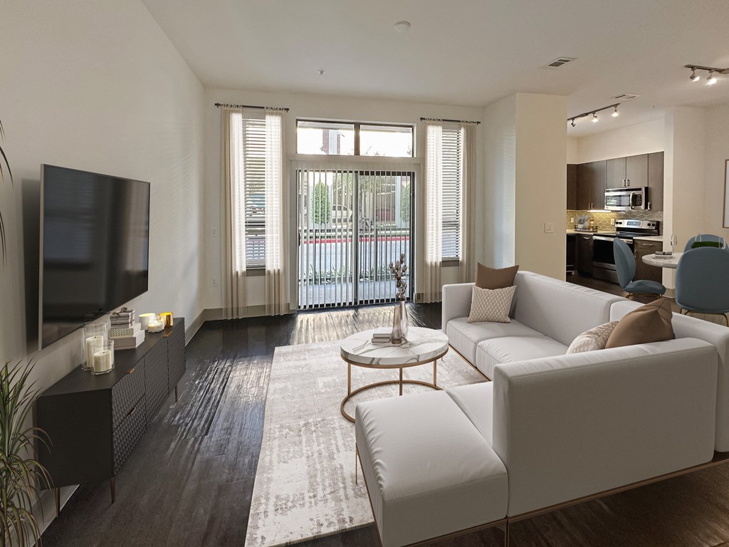 a living room with a white couch and a television