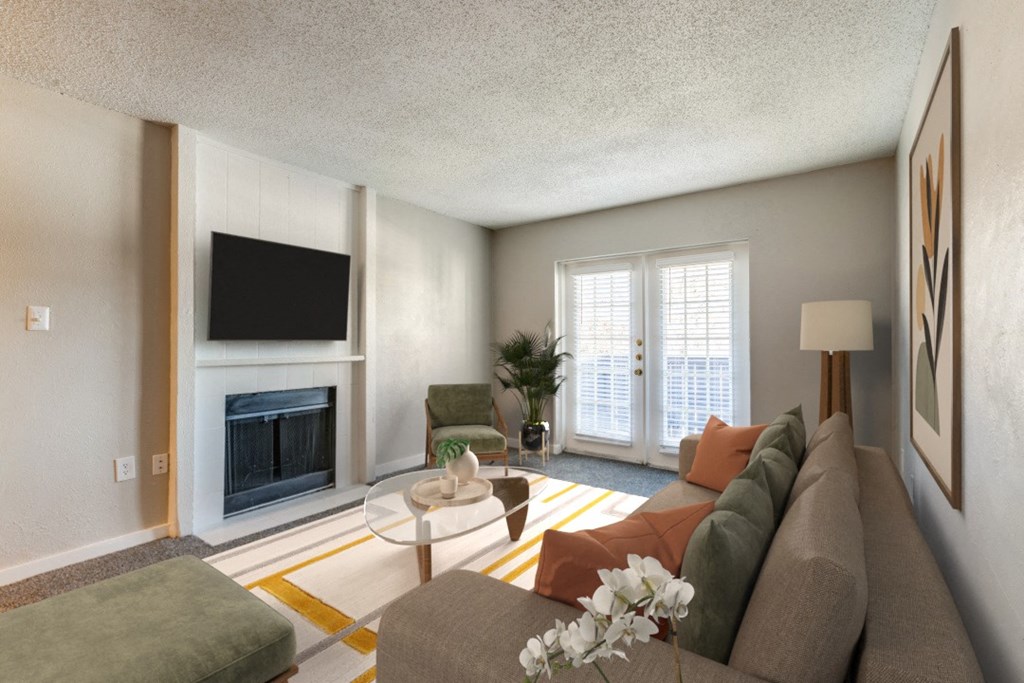 a living room with a couch and a table and a fireplace