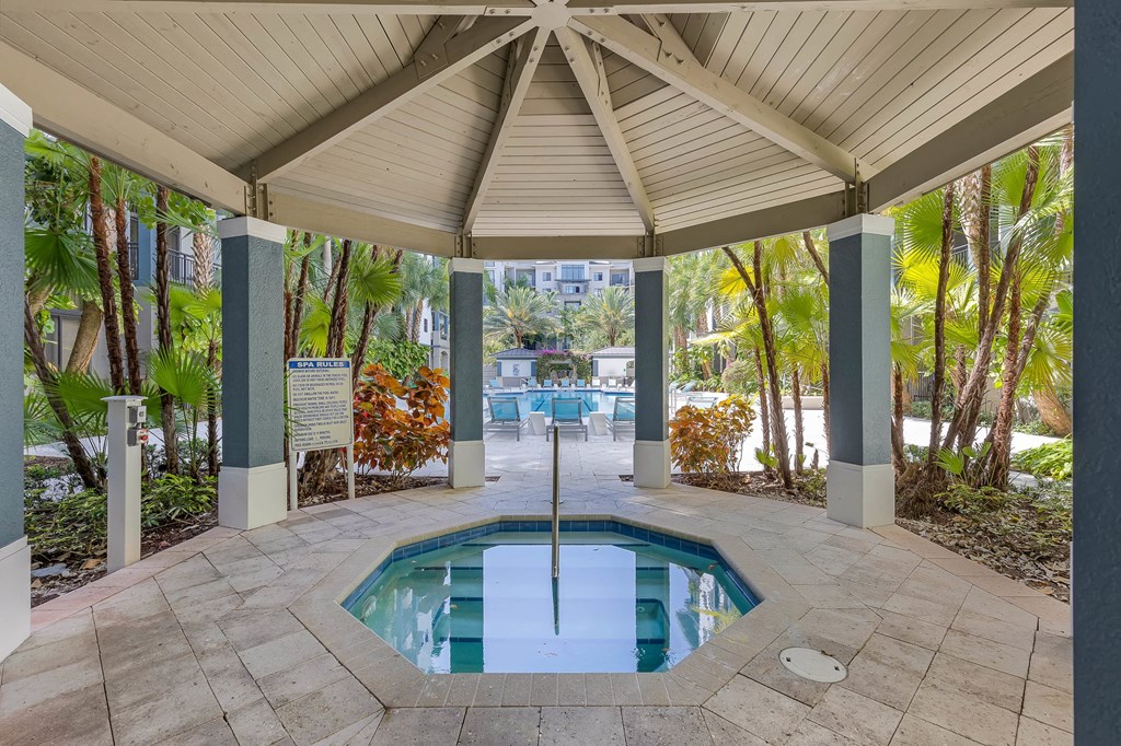 the pool is under a covered patio with a pool