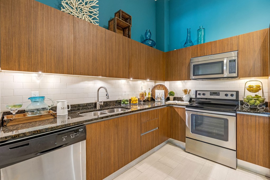 a kitchen with stainless steel appliances and wooden cabinets