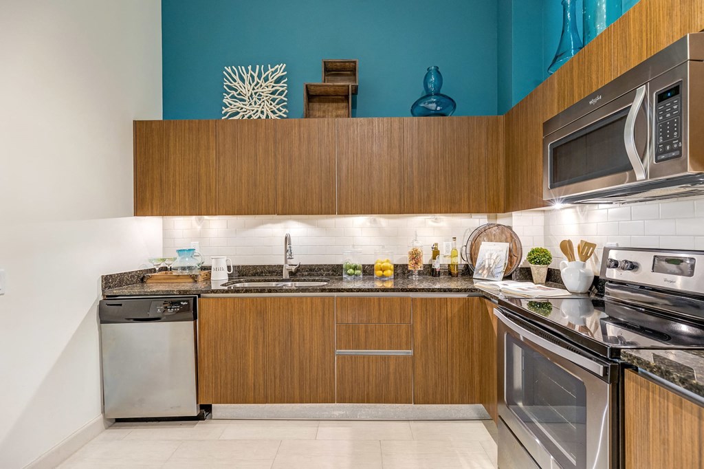a kitchen with stainless steel appliances and wooden cabinets