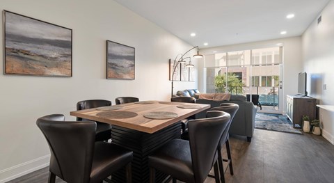 A dining room with a wooden table and chairs.