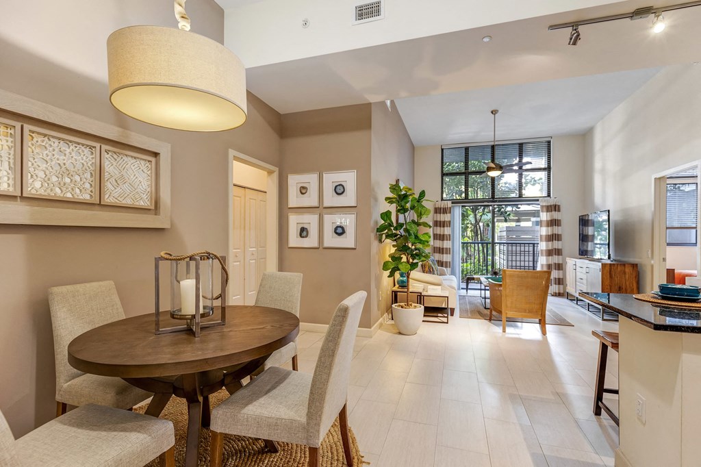 a dining room and living room with a table and chairs