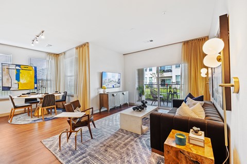 A living room with a brown couch and a coffee table.