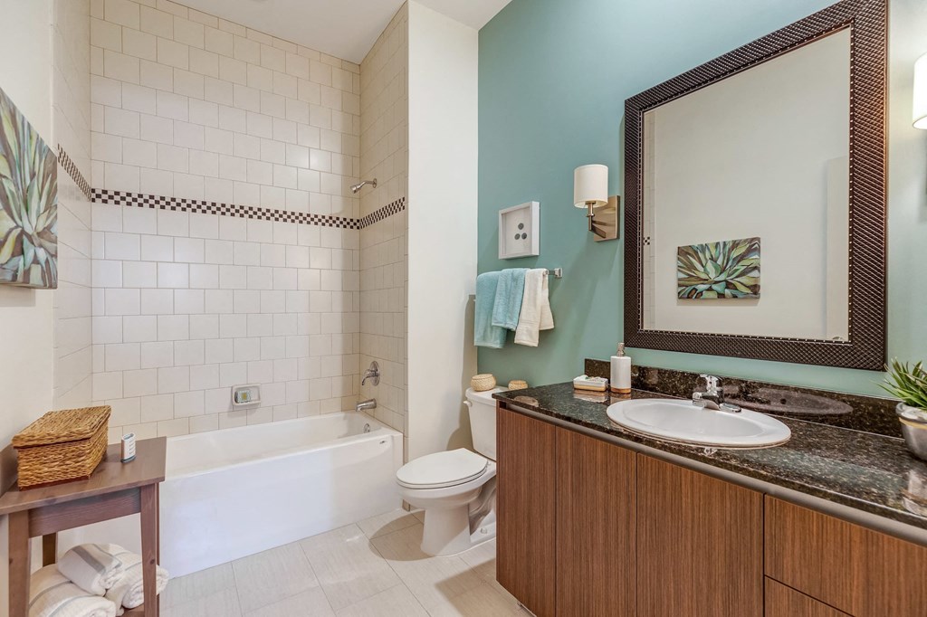 a bathroom with a sink toilet and a bath tub
