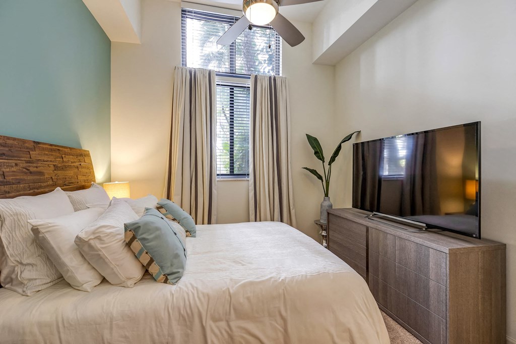 a bedroom with a large bed and a tv