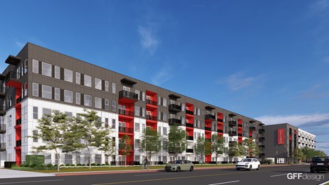 A modern building with a combination of grey and red sections.