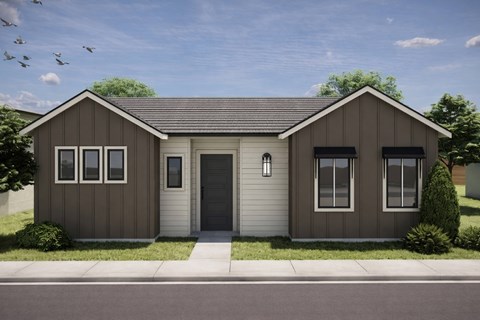 A modern house with a grey front and a brown roof.
