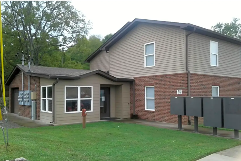 a house with a grassy yard in front of it