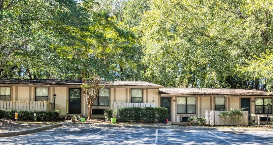 a house with a tennis court in front of it