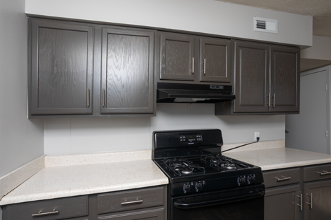 a kitchen with black appliances and white counter tops