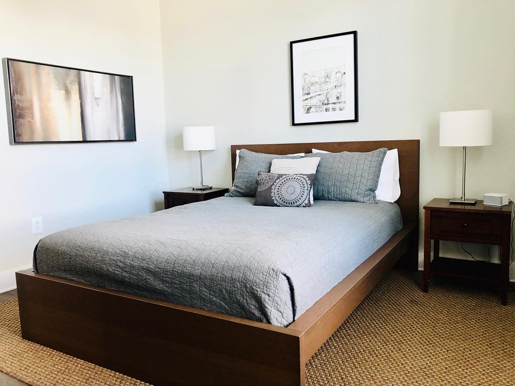 a bedroom with a bed and two nightstands