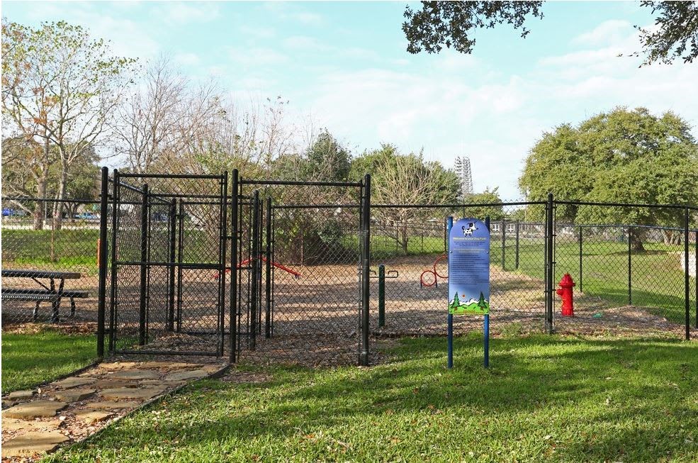 a park with a fence and a fire hydrant
