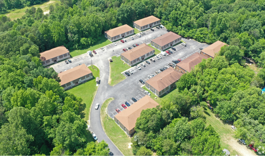 an aerial view of a parking lot and buildings