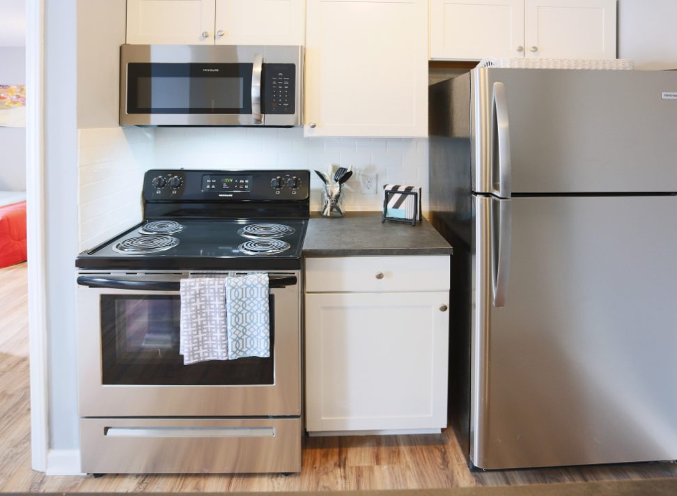a kitchen with stainless steel appliances and a stove and refrigerator