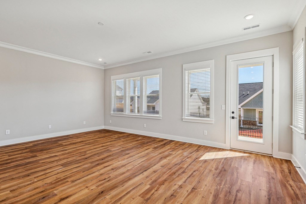 A room with wooden floors and white walls.