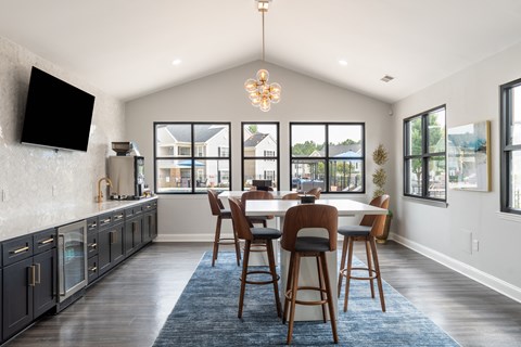 A dining room with a table and chairs.