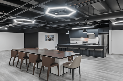 A modern dining area with a long table and chairs.