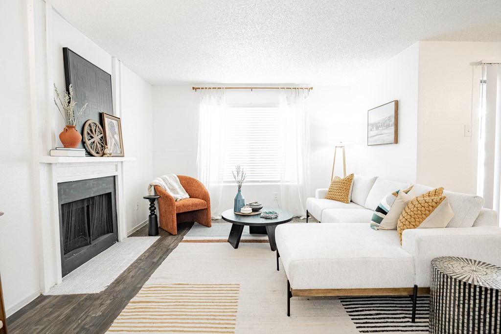 a living room with a white couch and a fireplace