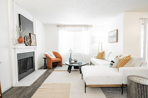 a living room with a white couch and a fireplace