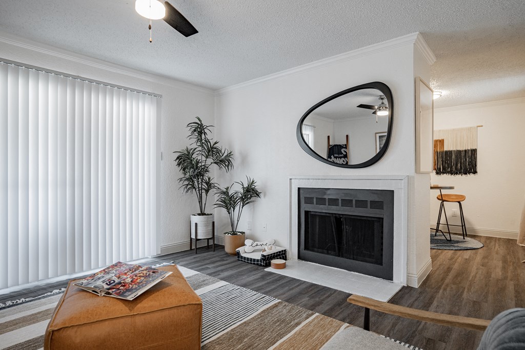 a living room with a fireplace and a mirror