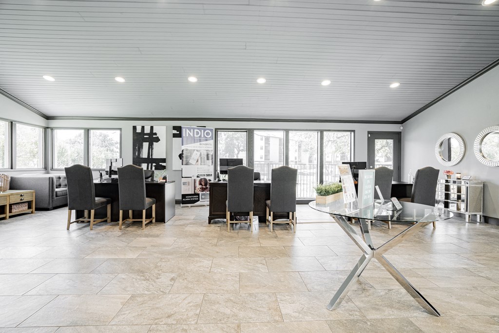 a living room with a table and chairs and a dining room