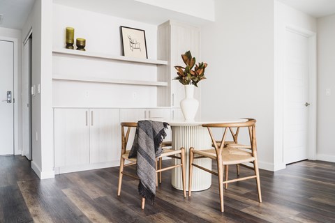 A dining room with a table set for two.