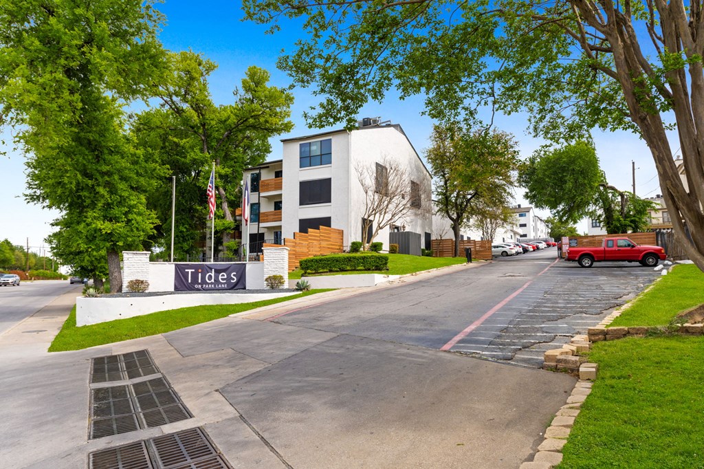 a street with a red truck parked in front of a building with a sign that says tides