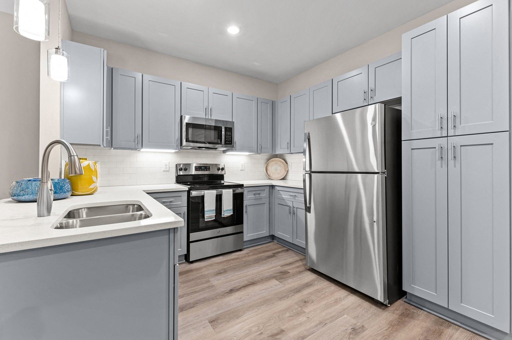 a kitchen with stainless steel appliances and white cabinets
