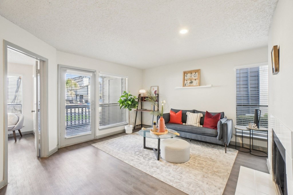 A living room with a grey couch and a white coffee table.