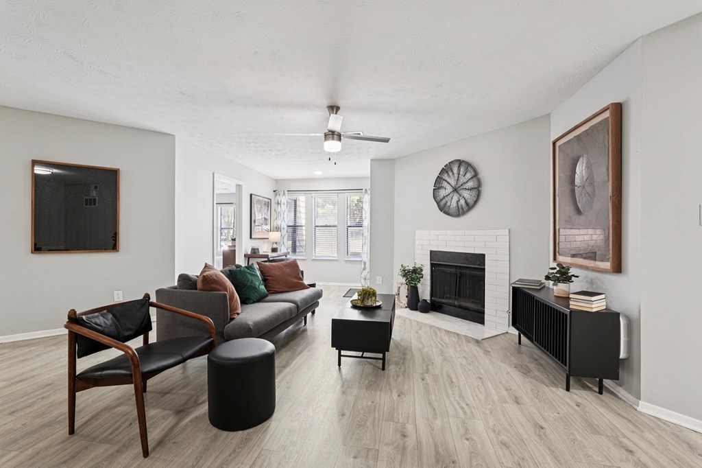 A living room with a fireplace and a painting on the wall.
