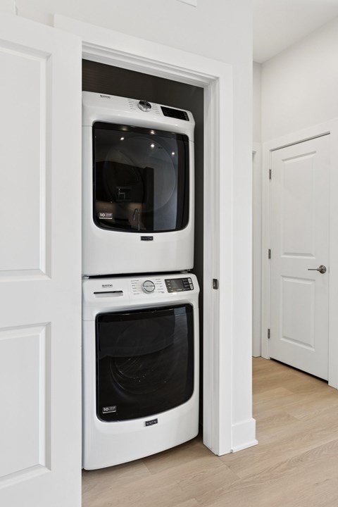 A white double oven built into a kitchen cabinet.