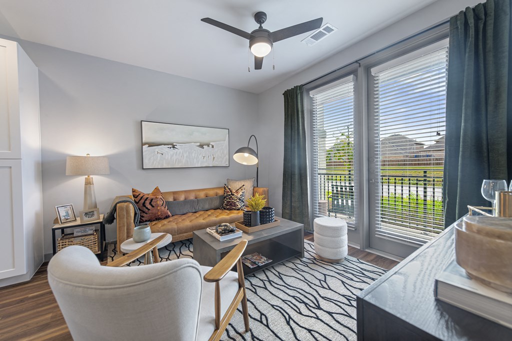 a living room with a couch and a ceiling fan